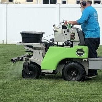 Landscape professional applying a lawn treatment.